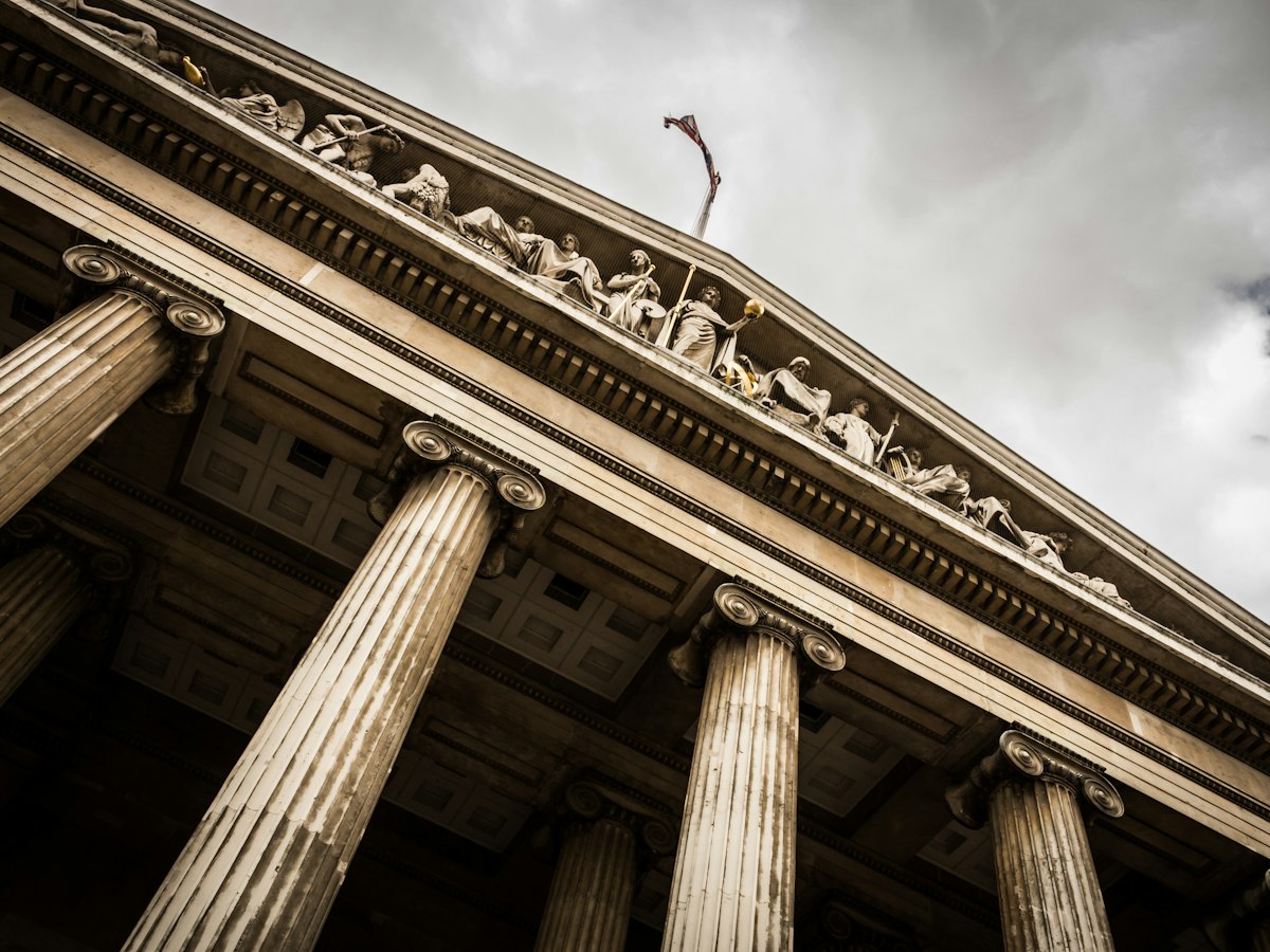 Warm stone columns and carved pediment of the British Museum in London