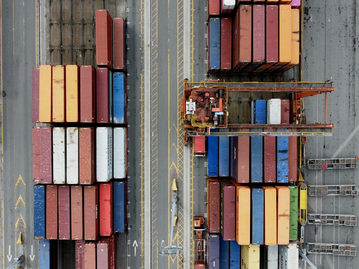 Aerial view of shipping containers and a gantry crane at Vancouver port
